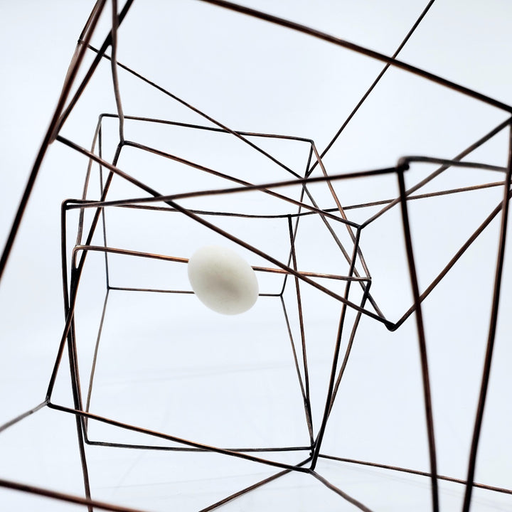 "Inner Space" - This interlocking multi-cube line sculpture in copper with a white resin "egg" has various resting positions