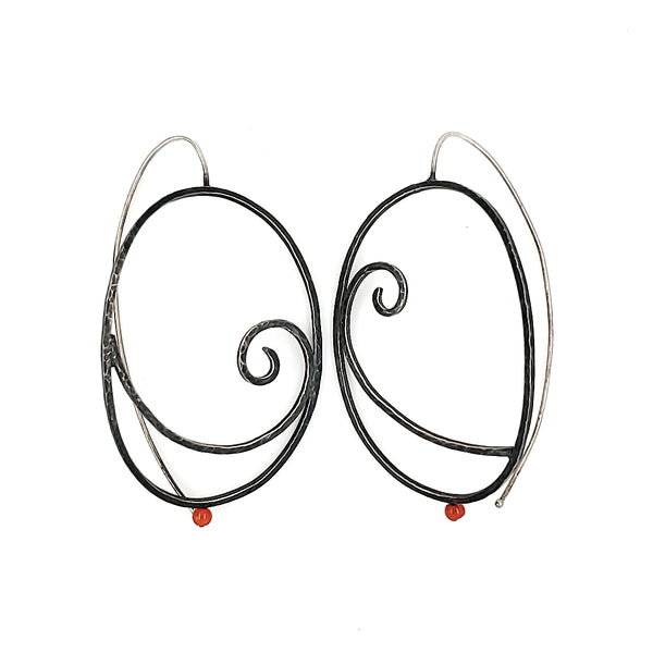  "Art Déco" earrings are large sterling silver hoops with punctuated with a red-orange coral bead.