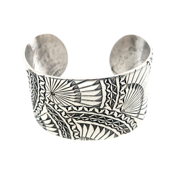 Wide sterling silver cuff bracelet with hand stamped Japanese fan pattern. Size large.