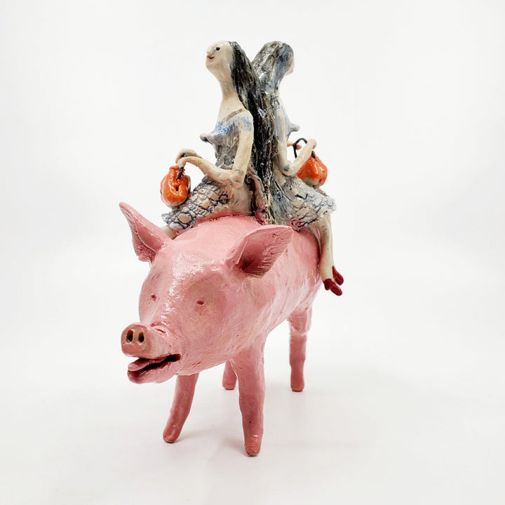 To Market, To Market: Ceramic figure of a pig with twin witches on its back, each holding orange purses.
