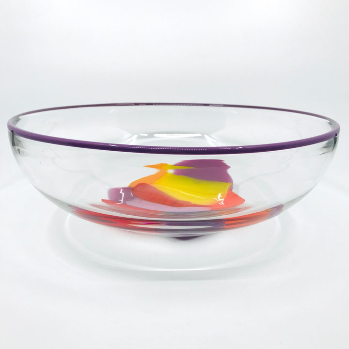 Storm Bowl of hand blown glass. One of a kind bowl in warm tones of purple, red, and yellow. 27 x 27 x 9.5 cm.