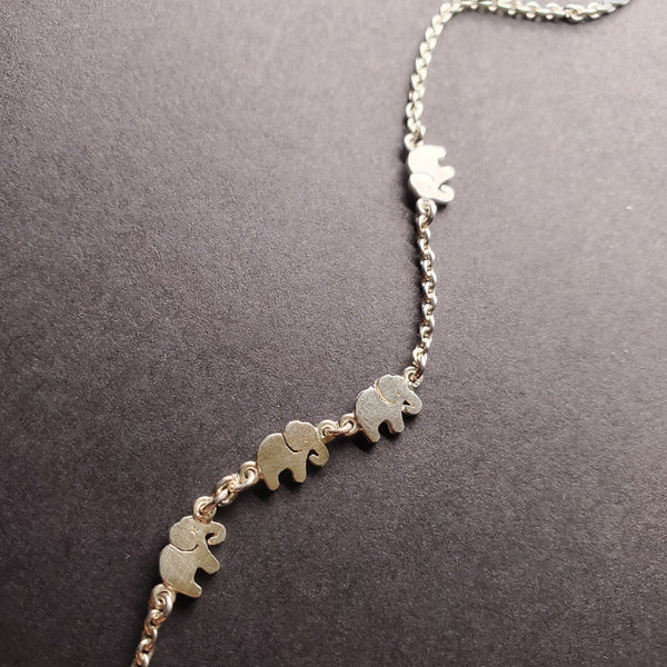 Sterling silver anklet with elephant pattern.
