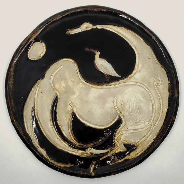 Ceramic plate depicting two horses. 12" in diameter.