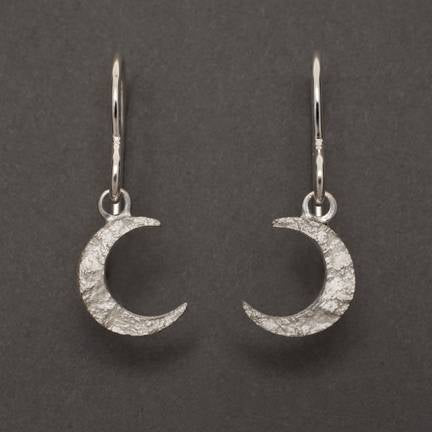 Allyson Simmie's Crescent moon earrings in sterling silver textured by the impression of granite. Currently available as drops studs 25 x 5 c or studs, 10 x 6 mm; contact us for Crescent Moon Drops. 