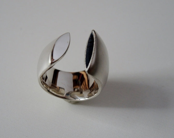 Large rounded and polished open band with one oxidized and one polished sterling silver end approx.18mm wide, size 6.5