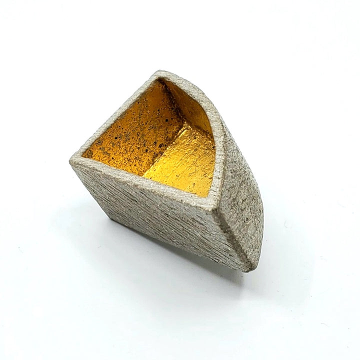 Arc box pin of concrete with  a 24K gold interior. 