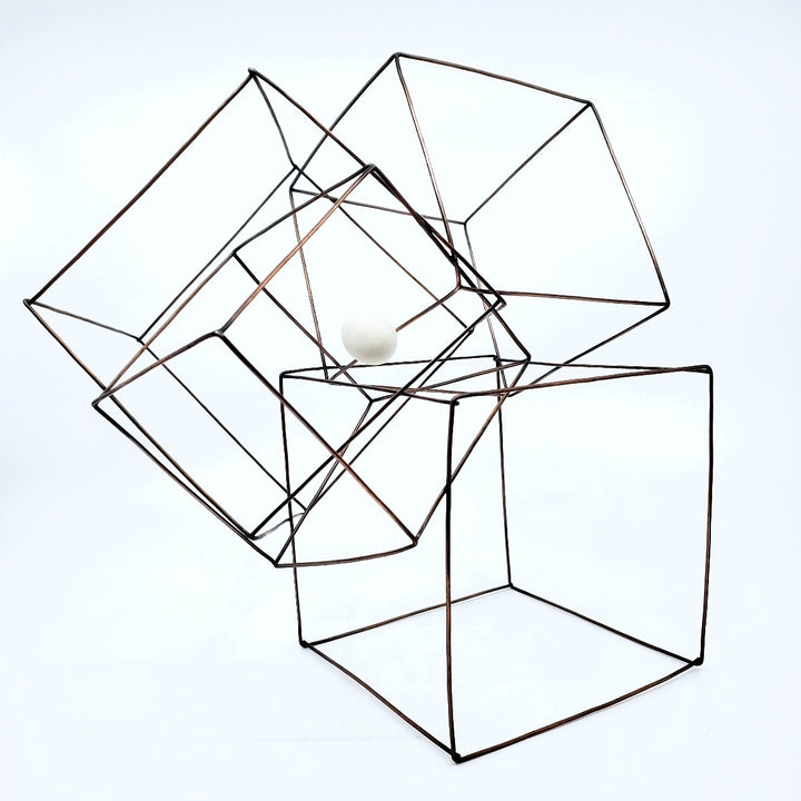 "Inner Space" - This interlocking multi-cube line sculpture in copper with a white resin "egg" has various resting positions