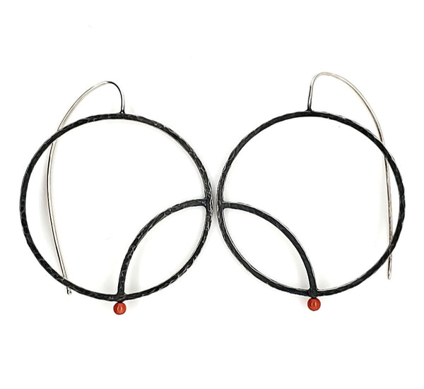  "Art Déco" earrings are large sterling silver hoops with punctuated with a red-orange coral bead.