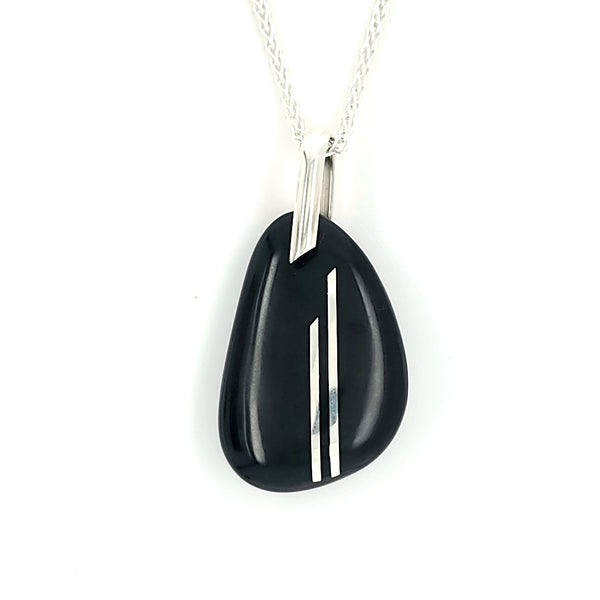 Pebble pendent embedded with sterling silver double line inlay on a 21" sterling silver wheat chain. The pebble itself measures 2.8 x 4.2 x 0.7 cm.