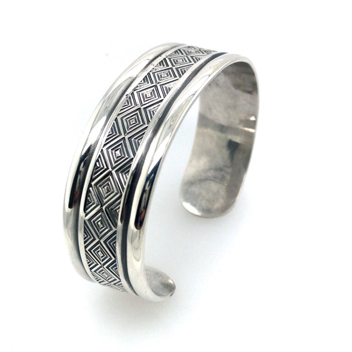 Stamped sterling silver cuff bracelet with border. Size large.