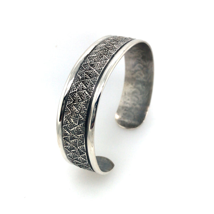 Stamped sterling silver cuff bracelet with border. Size large.