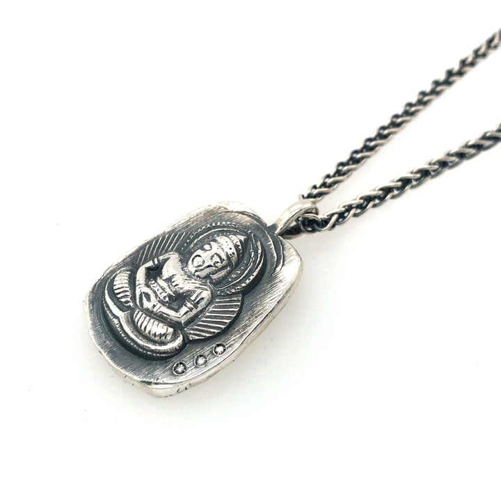 Buddha medallion pendant in sterling silver with 3 diamonds.