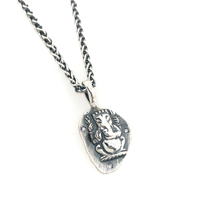 Small Ganesh pendant cast in sterling silver, with 3 diamonds. 