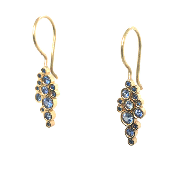 Vibrant blue sapphires glow in these 18k yellow gold earrings.