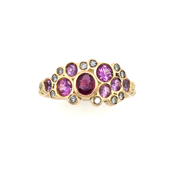 Phenomenal pink sapphires and diamonds sparkle in this floral 18k yellow gold band. Size 8.