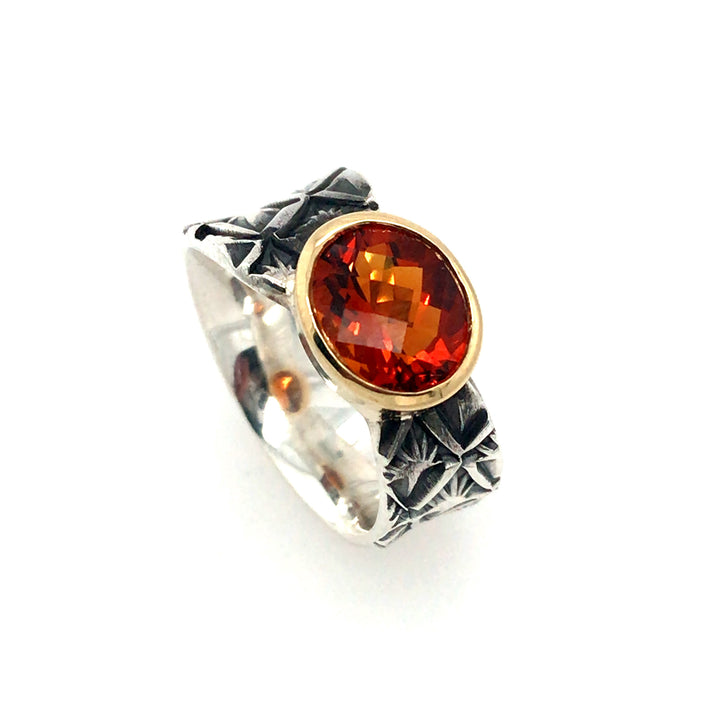 Hand stamped sterling silver ring with a fire-bright orange quartz in an 18k gold bezel. Size 6.