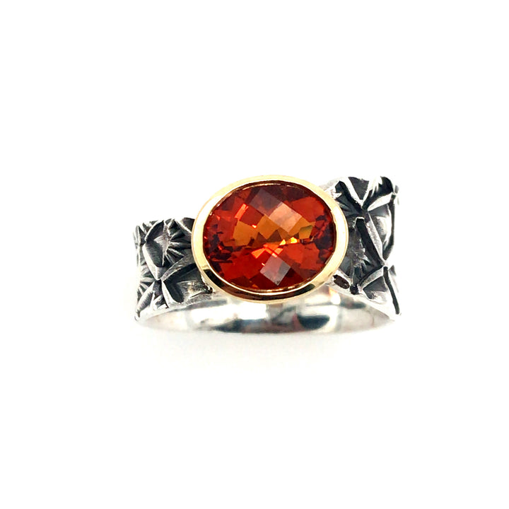 Hand stamped sterling silver ring with a fire-bright orange quartz in an 18k gold bezel. Size 6.