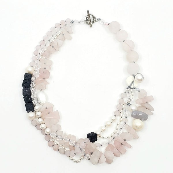 Multi-strand necklace of lava stones, rose quartz, and pearls, hand-knotted between each bead, with a sterling silver clasp.