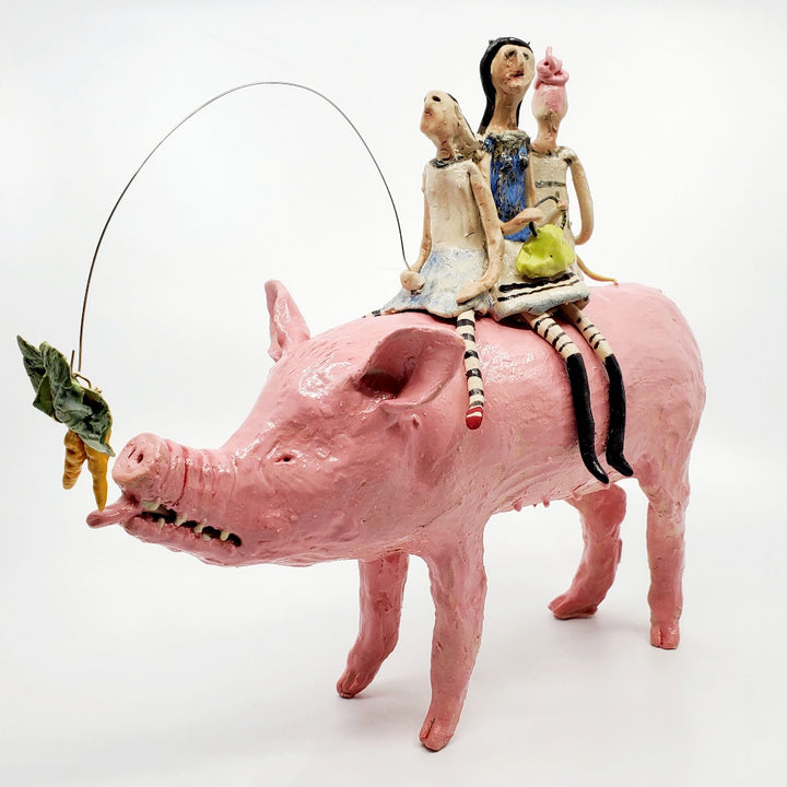 Buyers Market, 2023. Witches ride to the market on the back of a pig, which follows a tempting carrot. 
