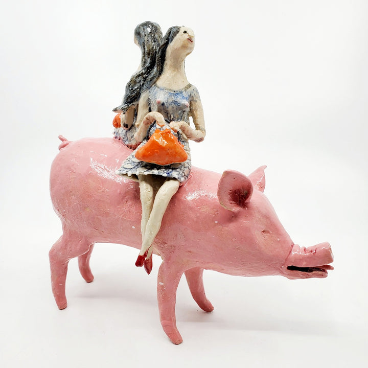 To Market, To Market: Ceramic figure of a pig with twin witches on its back, each holding orange purses.