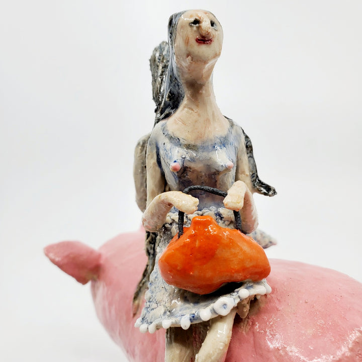 To Market, To Market: Ceramic figure of a pig with twin witches on its back, each holding orange purses.