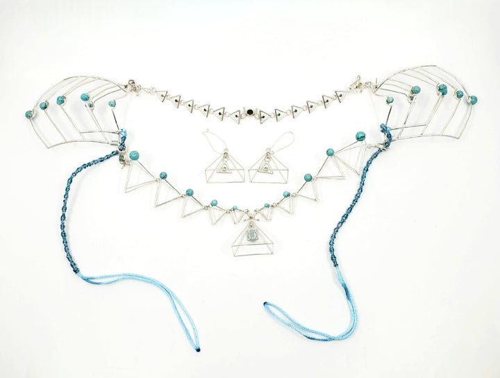 Azure Dragon (青龙), 2023.   This hand fabricated set with pauldrons--which can be separated into a neckpiece, brooches, and earrings--is made from sterling silver, Chinese jade, Chinese turquoise beads, Vancouver jade, and emerald. Every part is detachable and can be worn separately.