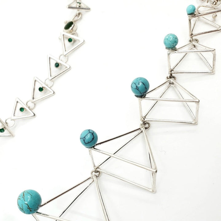 Azure Dragon (青龙), 2023.   This hand fabricated set with pauldrons--which can be separated into a neckpiece, brooches, and earrings--is made from sterling silver, Chinese jade, Chinese turquoise beads, Vancouver jade, and emerald. Every part is detachable and can be worn separately.