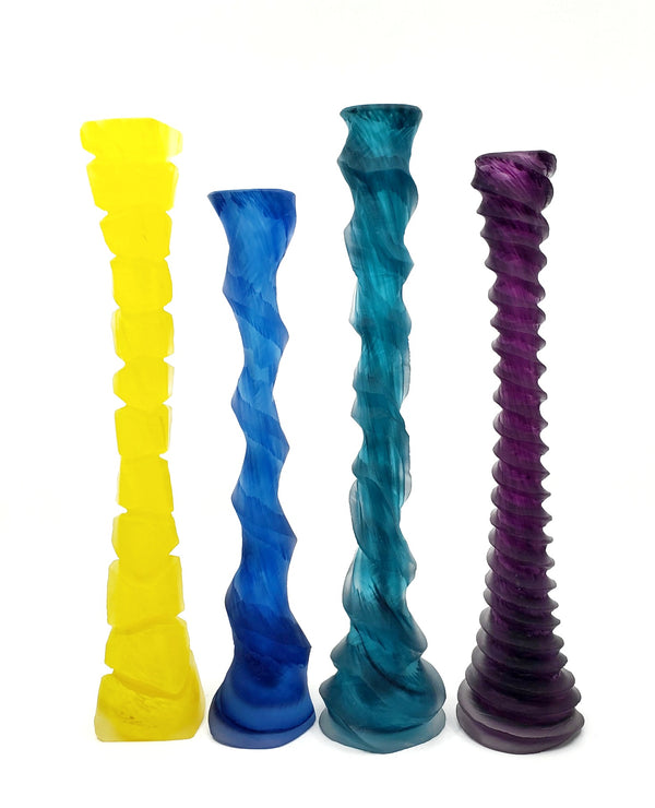Blown and carved candlesticks in a variety of colours. 