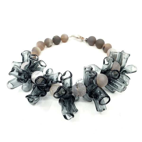 Necklace of handmade grey borosilicate glass beads and grey agate beads, with a silver clasp. 