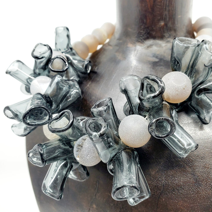 Necklace of handmade grey borosilicate glass beads and grey agate beads, with a silver clasp. 