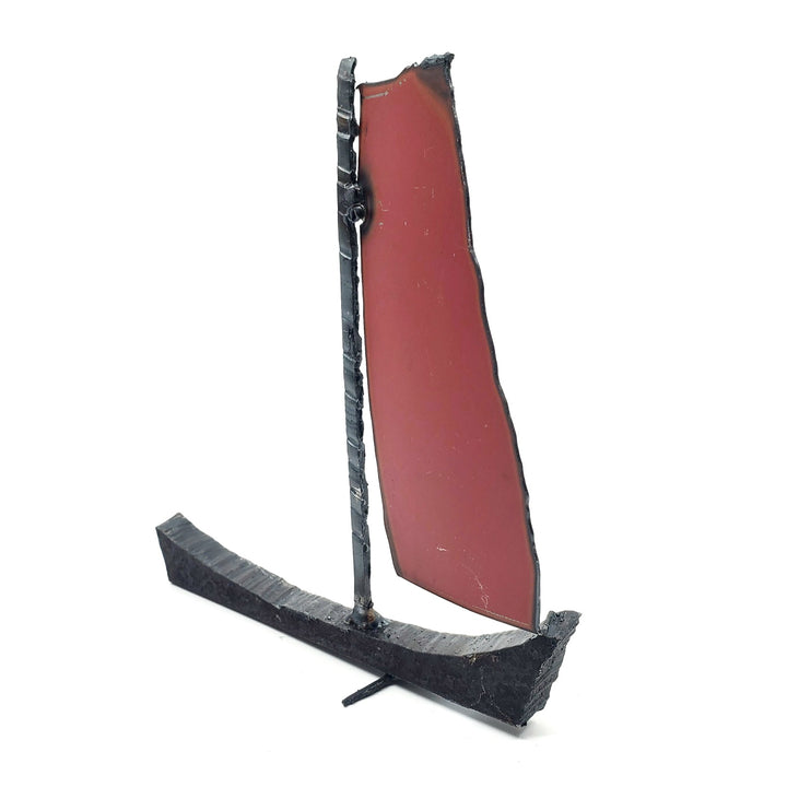 Bateau - Small red and orange boat of welded repurposed iron. The sail is red on one side, and orange on the other.
