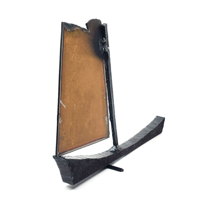 Bateau - Small orange boat of welded repurposed iron. The sail is orange on one side, and silver on the other.