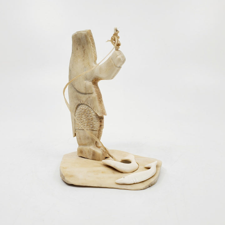 Fisherman, caribou antler carving by artist Simo Kilabuk of Arviat, Nunavut. 