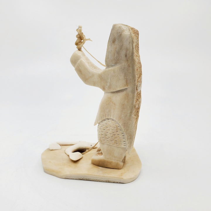 Fisherman, caribou antler carving by artist Simo Kilabuk of Arviat, Nunavut. 