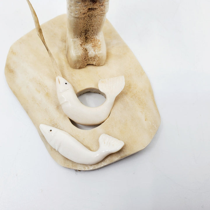 Fisherman, caribou antler carving by artist Simo Kilabuk of Arviat, Nunavut. 