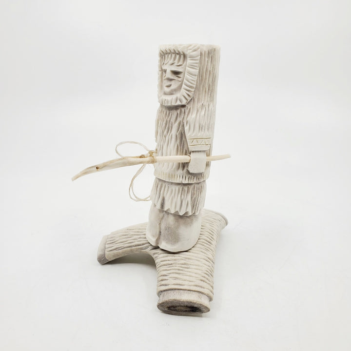 Hunter, caribou antler carving by artist Thomas Nibgoarsi of Arviat, Nunavut.