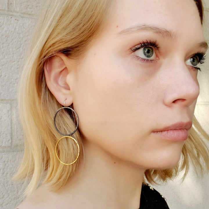 Faire des ronds dans l'eau.  Large, timeless double-circle earrings of forged sterling silver and 14k yellow gold,  7 x  3 cm.