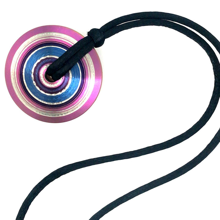 Chroma: pendant of pink, blue, and silver lathed and anodized titanium