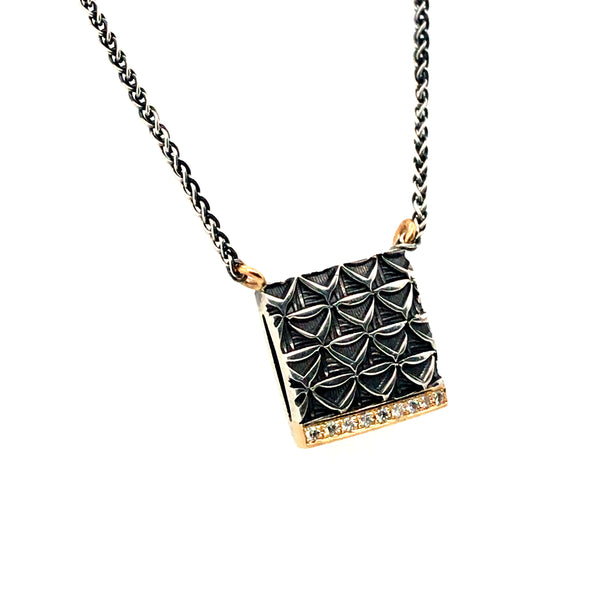 Hand stamped sterling silver necklace. This square pendant has a line of 18k yellow gold and diamonds.