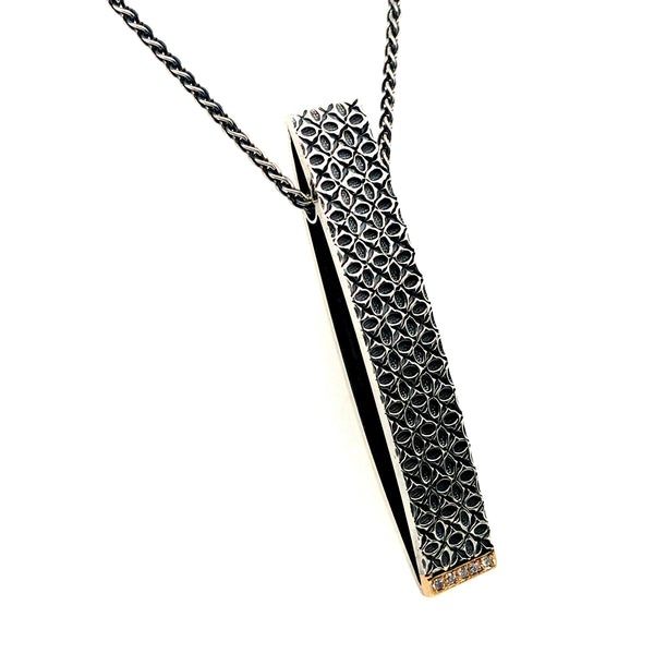 Long rectangular pendant in sterling silver & 18k gold, with a line of diamonds at the bottom.
