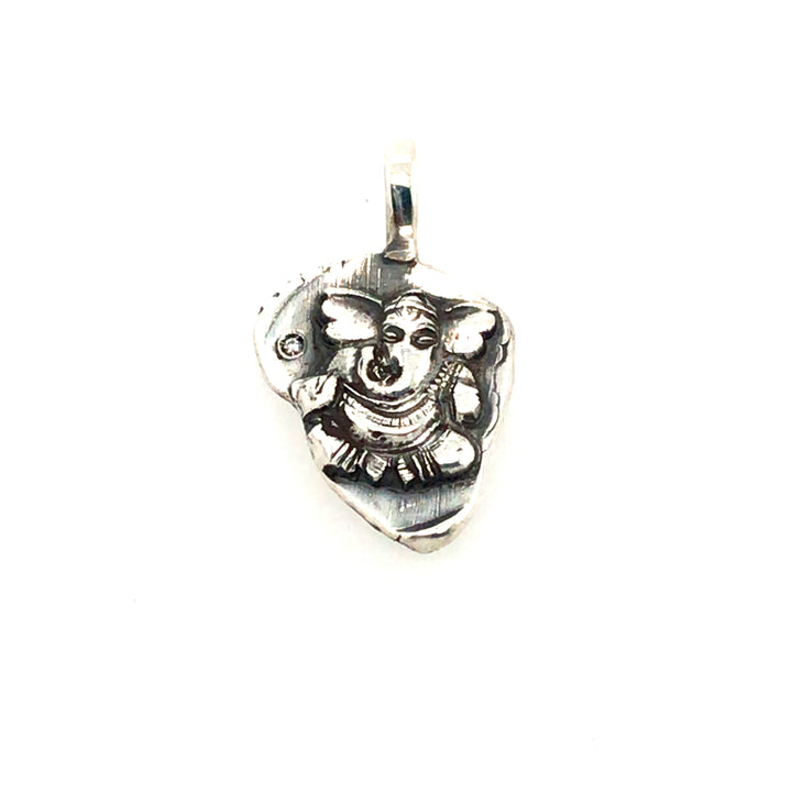 Small Ganesh pendant in sterling silver, with a single diamond to the left of the figure.