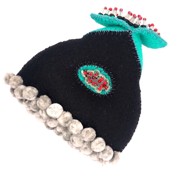 Black and turquoise wool brooch with glass beads and thread.