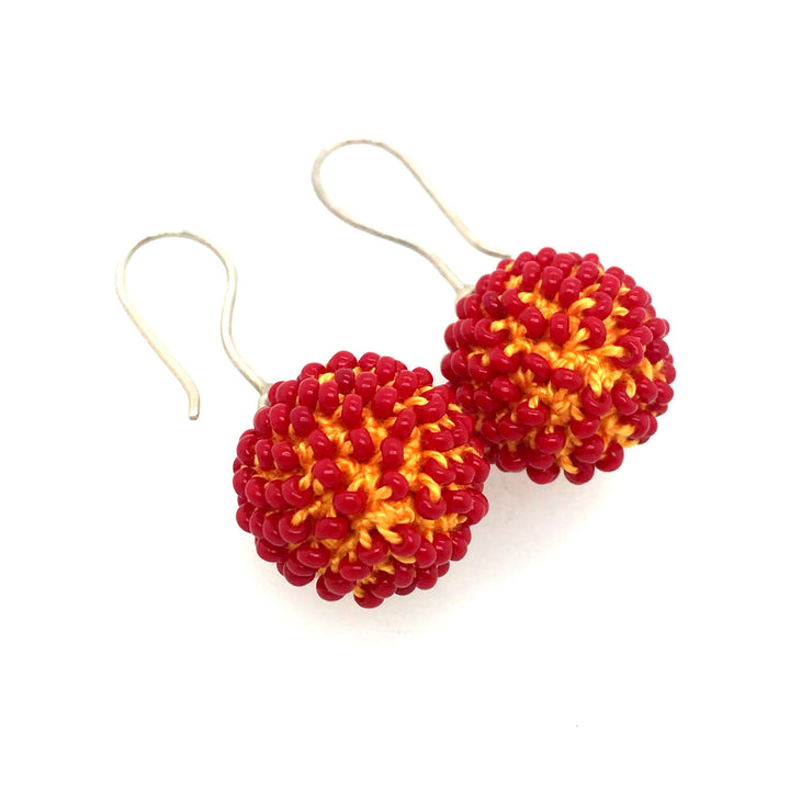 Short Red and Orange Earrings. Red glass beads are sewn in with orange thread.