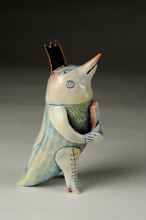 Bird - Small ceramic sculpture of cone 6 stoneware finished with glazes and underglazes. A bird-like figure in thigh-high boots cradles a house in their hands.