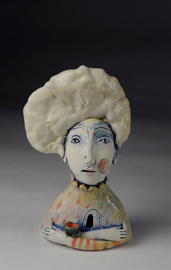 Portrait with Nest - Small ceramic sculpture of cone 6 stoneware finished with glazes and underglazes. A small nest or bowl balances on the figure's crossed arms. 
