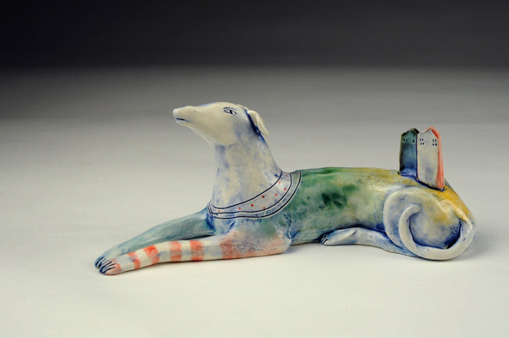 Dog With House - Small ceramic sculpture of cone 6 stoneware finished with glazes and underglazes. Two houses balance on the back of this resting dog. 