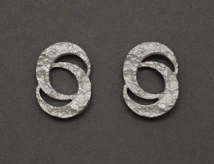Double crescent moon earrings in sterling silver textured with impressions of granite on each of the slivers of interlocking moon (which sing of togetherness!).  This pair is currently available as studs, approx. 6 mm. Please contact us for drops.