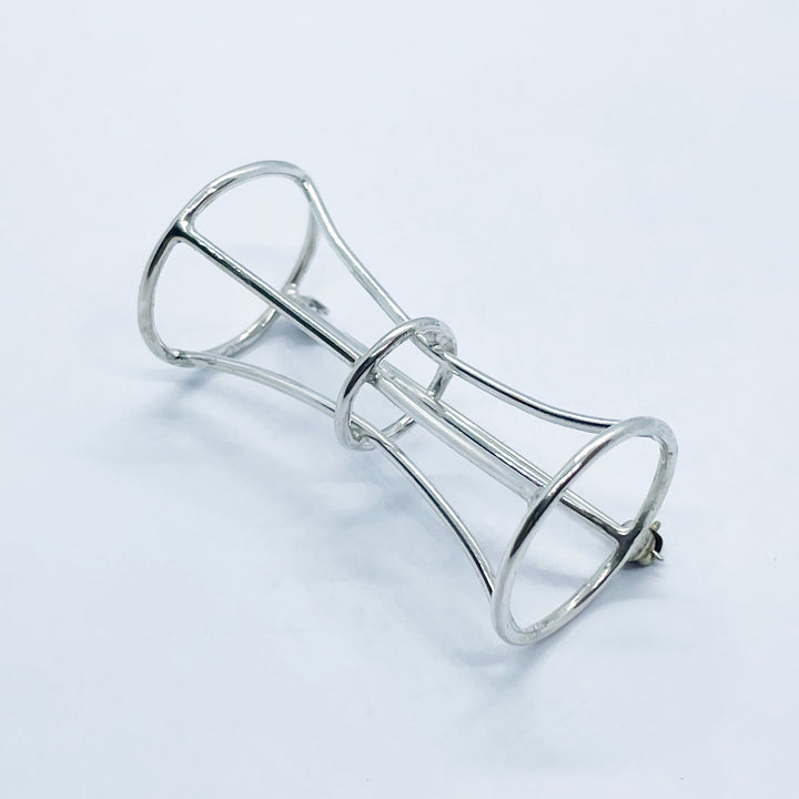 Bamboo report peace brooch, 2022.  Hand fabricated sterling silver brooch.  2.5 x 4.5 x 2.5 cm