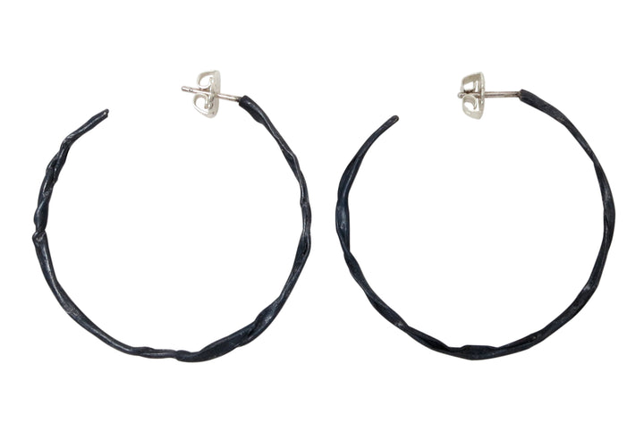 Fold black stationary hoop earrings in oxidized sterling silver.