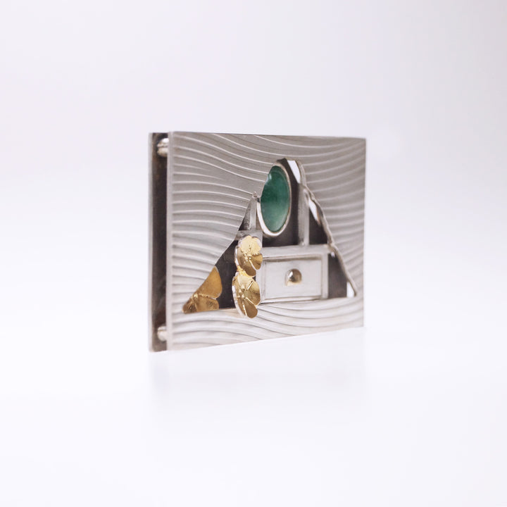 Hometown: Taiwan Duobaoge (curio boxes) - Silver Brooch, 2022.  Created with cold connection (riveting, rolling printing, bezel setting, oxidation, and Keum-boo, this brooch is made of sterling silver, 18k yellow gold, gold foil, and jade. The inside elements can be customized.  6x3.6x0.7cm